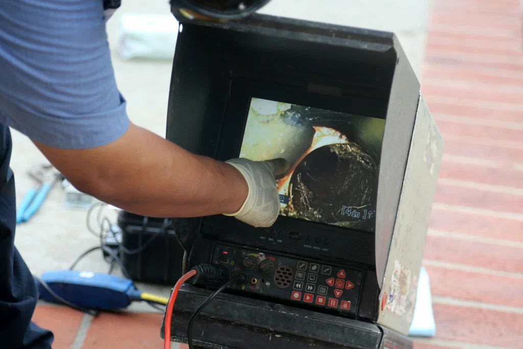 Technician viewing a drain inspection camera in Tucker