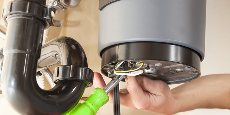 Technician repairing the heating element of a water heater in Tucker